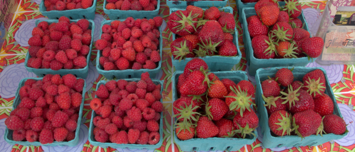 boxes of raspberries and strawberries